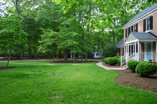 Large Grassy Yard In Front Of Brick Colonial Home