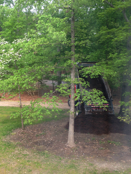 Mulch Dump Truck Dumping Pile Of Mulch In Front Of Home