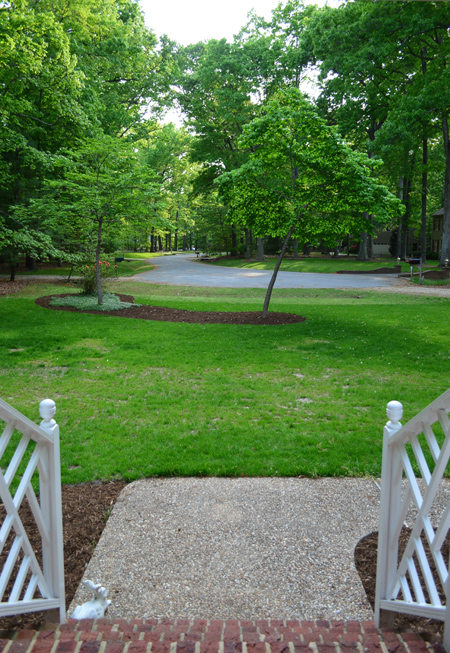 View From Front Door At Large Grassy Lawn With Mulch Beds Around Trees