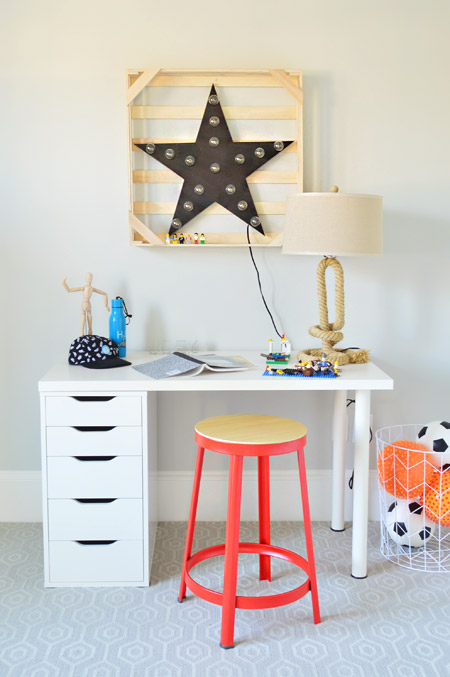 Desk In Boys Room With Colorful Orange Stool and Vintage Star Wall Hanging Light