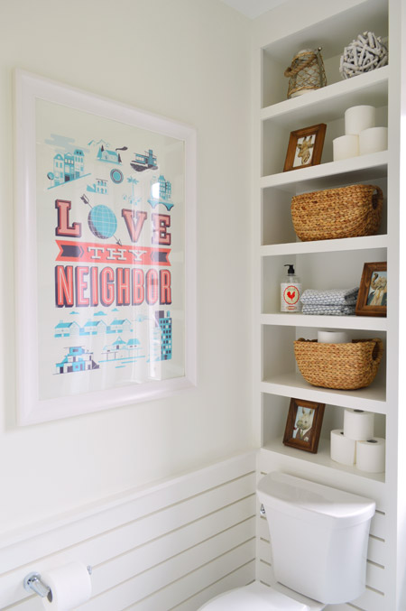 Bathroom With Built In Shelves Above Toilet and Slatted Wainscoting