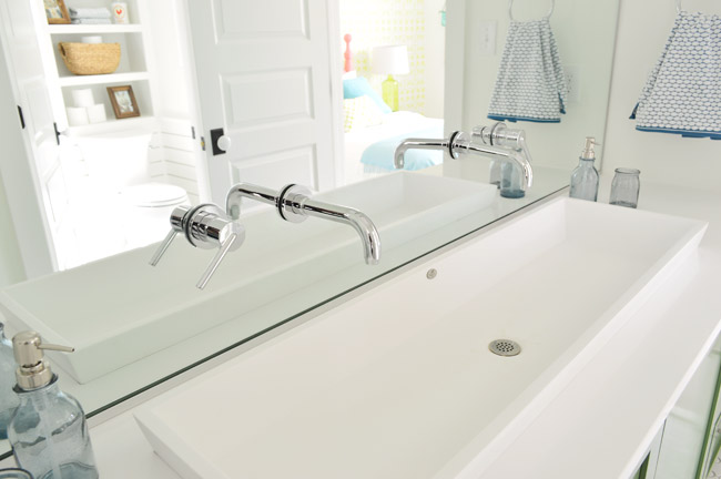 Detail Of Vessel Sink With Faucets Coming Out Of Mirrored Wall