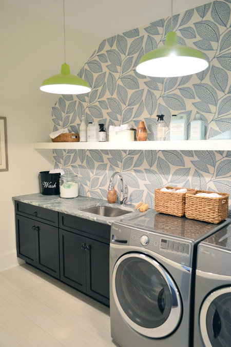 Laundry Room With Dark Cabinets and Large Leafy Wallpaper Print