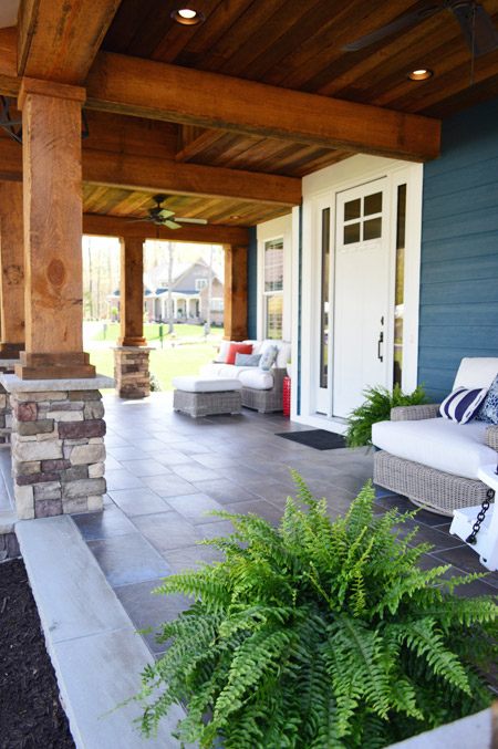 Rustic Porch With Large Wood Beams And Stone Columns