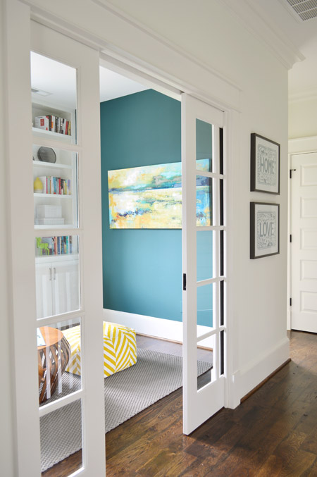 Glass pocket sliding doors into dark reading game room