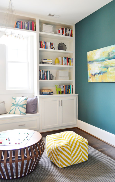 Built-In Bookcases In Game Room With Dragonfly Painted Green Walls