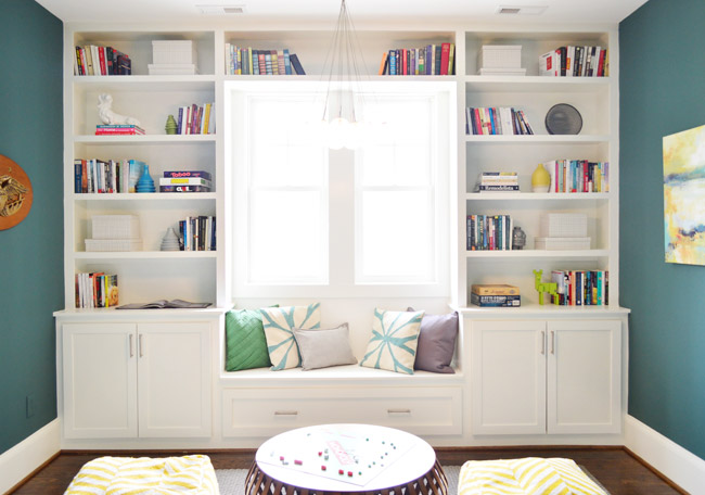 Built-In Bookcases In Game Room Painted White With Dragonfly Walls