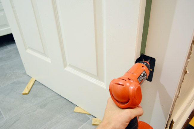 Hanging Door In DIY Jamb Using Screwdriver To Attach Door Hinges