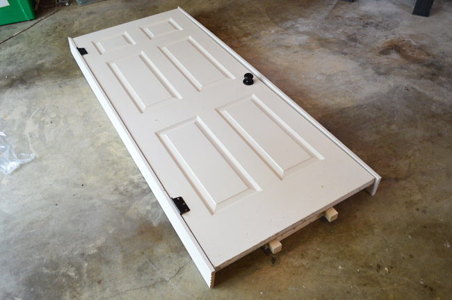 Paneled Door Loosely Fit In Layout Of DIY Door Jamb On Garage Floor