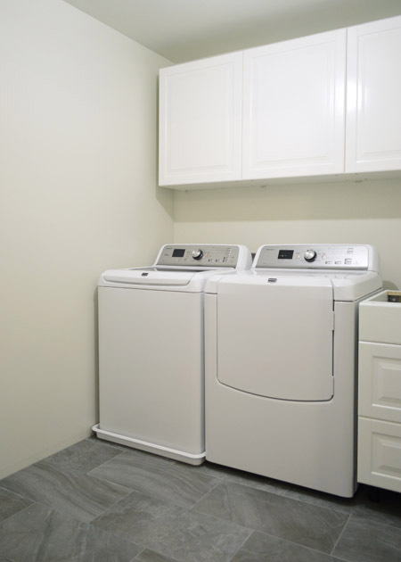 washing machine and drain pan, next to a dryer