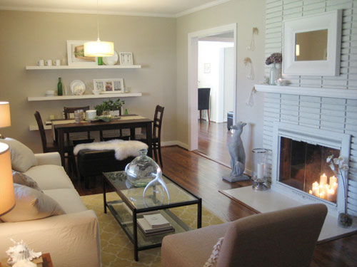 neutral decorating living room and dining room combination with brick fireplace